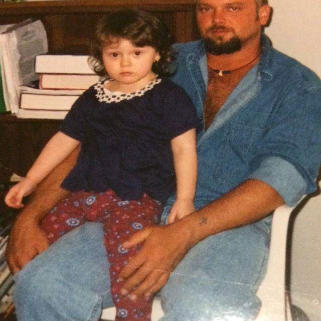 Rose on her father's knee