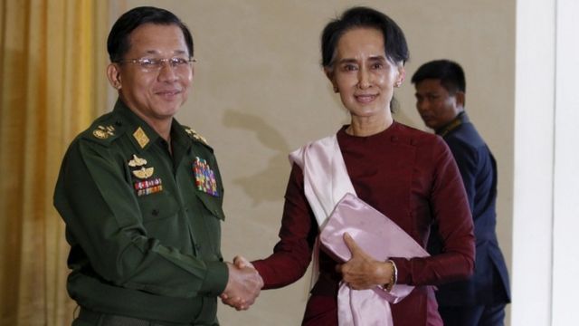 Min Aung Hlaing shakes hands with National League for Democracy (NLD) party leader Aung San Suu Kyi in December 2015