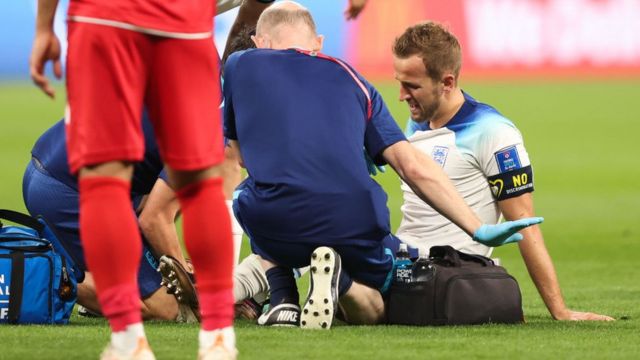 England's Harry Kane reacts after being injured during the match against Iran at the Khalifa International Stadium on November 21, 2022 in Doha, Qatar.