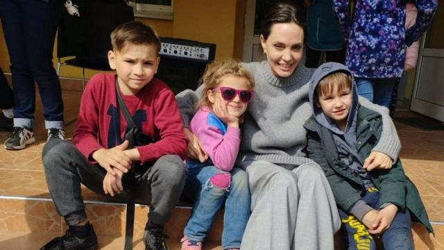 American movie star and UNHCR envoy Angelina Jolie poses with children in Kyiv, April 30, 2022