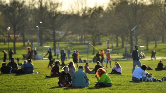 A group of people gather in London Park.