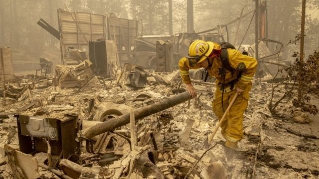 A firefighter examines wreckage in Berry Creek, California. Photo: 12 September 2020