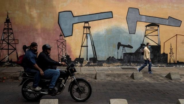 Murals with designs alluding to oil companies outside one of the buildings of the state-owned company Petroleos de Venezuela, in Caracas, Venezuela, 9 March 2022