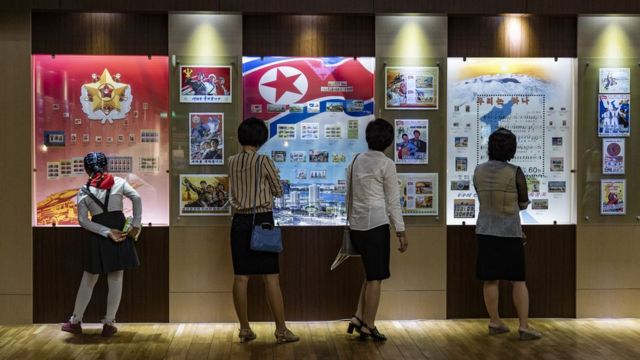 A young school girl (left), her mother (second from the left) and two women at the stamp museum in Pyongyang