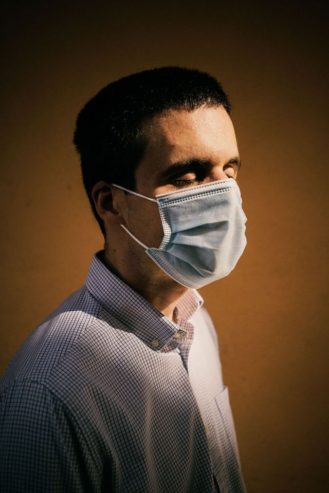 A portrait of a blind man wearing a face mask