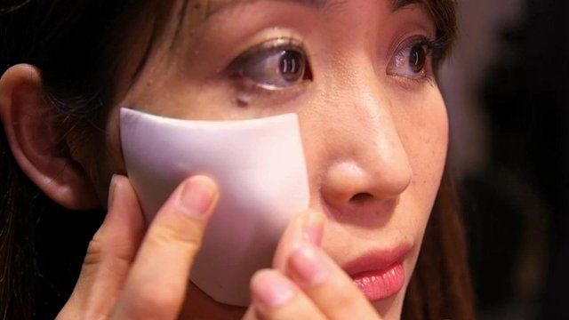 Masayo Fuchigami applying a personalised makeup patch created by a smart mirror she helped design