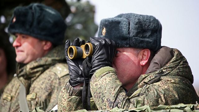 A Russian commander watches a military exercise in the Crimea on March 19, 2021