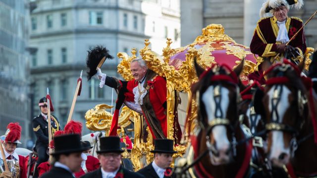 The Lord Mayor of the City of London, Alderman Peter Estlin, waves from his carriage during the Lord Mayor's Show on November 10, 2018 in London, England.