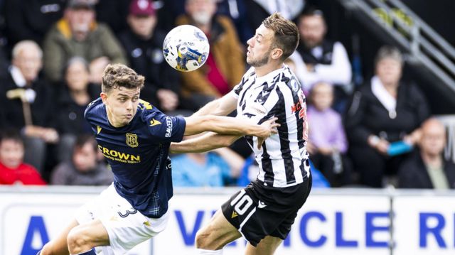 Conor McMenamin challenges Owen Beck to the ball