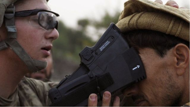2012年，一名美国士兵正在收集一名村民的生物识别信息。