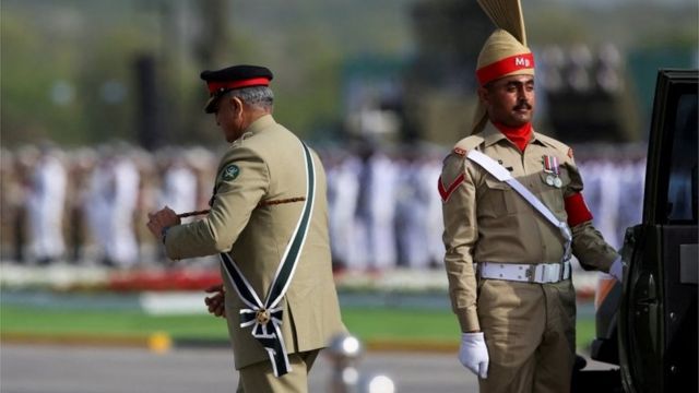 Pakistan's Chief of Army Staff, General Qamar Javed Bajwa, leaves his car upon his arrival to attend the Pakistan Day military parade in Islamabad, Pakistan, March 23, 2022.