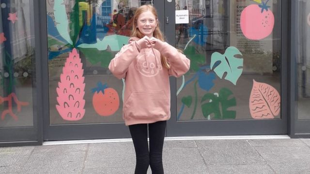 Freya standing outside the door to Great Ormond Street Hospital
