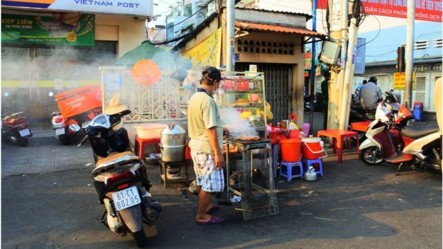 Xe đẩy bán cơm tấm lại tiếp tục nướng thịt trên lề đường ở dưới chân cầu Thị Nghè quận Bình Thạnh