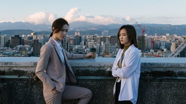 Hsieh Ying-xuan (left) and Gingle Wang on a rooftop overlooking Taipei in a scene from the Netflix show Wave Makers