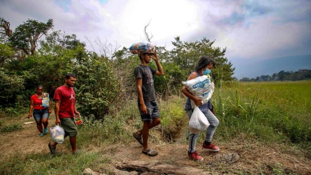Venezuelan citizens cross from Cucuta in Colombia back to San Antonio del Tachira in Venezuelavia an illegal trail on the border between the two countries