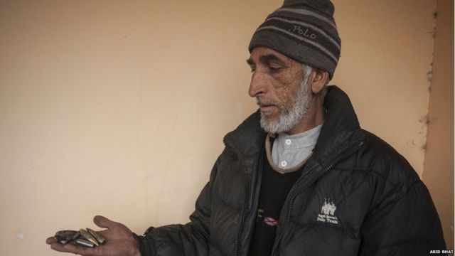 Mohammad Yaqoob holds empty bullet shells in his palm.