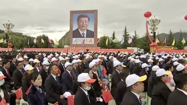 State media images show that the towering blue-bottomed portrait of Xi Jinping is three to four stories high.