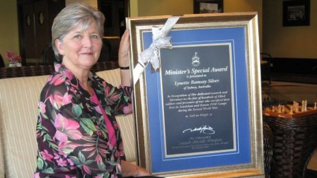 Lynette Silver with a framed copy of her certificate saying Minister's Special Award, which she was awarded by government authorities in Sabah, Malaysia