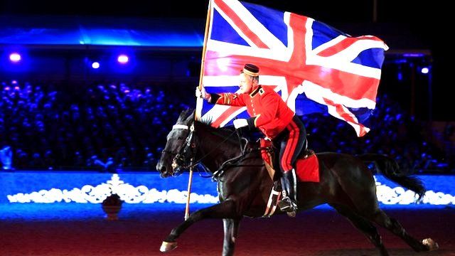 A Button Boy from the Household Cavalry rides through the arena during the Queen's 90th Birthday Celebration at the Royal Windsor Horse Show