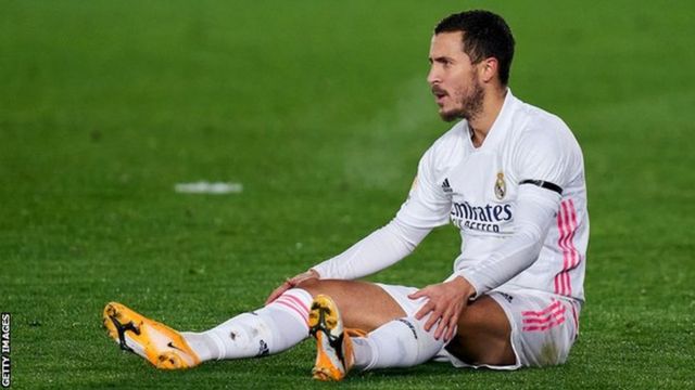 Eden Hazard sitting on the pitch