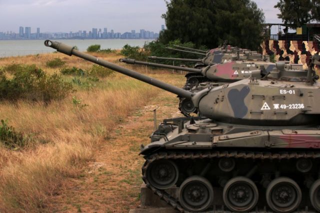 As the city of Xiamen, China, is seen in the background, retired M41 “Walker Bulldog” light tanks, which had served the Taiwanese Army for 63 years, are on display by a beach on October 7, 2023 in Kinmen, Taiwan.