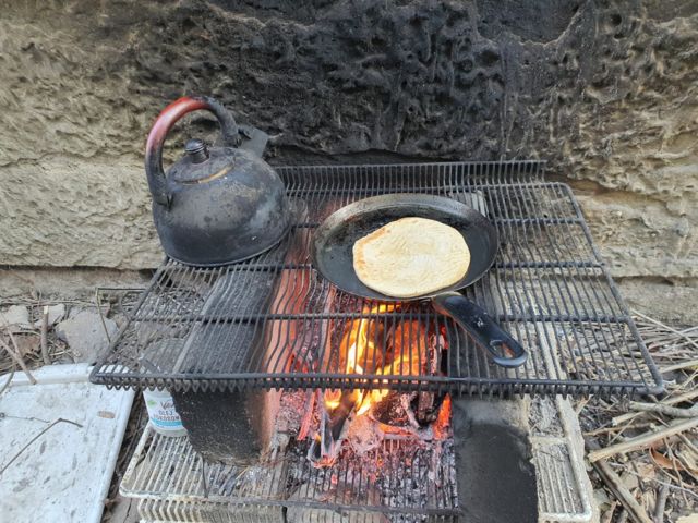 P&atilde;o e caf&eacute; feitos por Silvana no fog&atilde;o a lenha improvisado em frente ao pr&eacute;dio