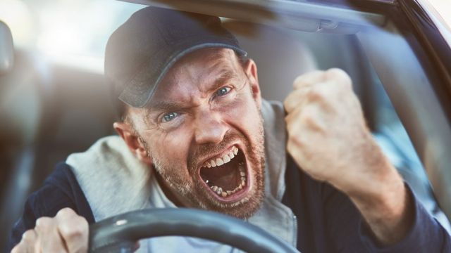 An angry man at the wheel of his car
