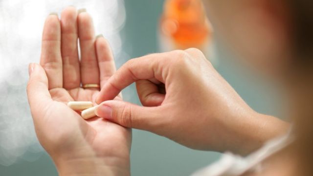 Pills in a woman's hand