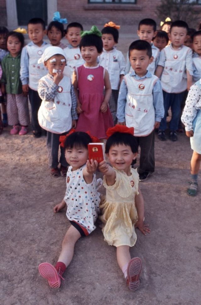 Beijing, China - School children hold Mao Zedong's Red Book during an essay in Beijing May 21 1971. (Photo by Vittoriano Rastelli/Corbis via Getty Images)