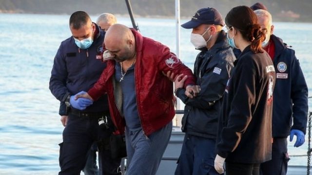 A passenger from Italian-flagged Euroferry Olympia disembarks from a Greek coast guard vessel at the port of Corfu