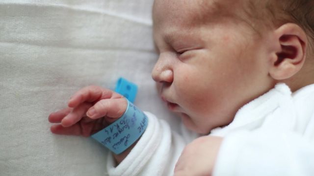 Baby with name tag on wrist