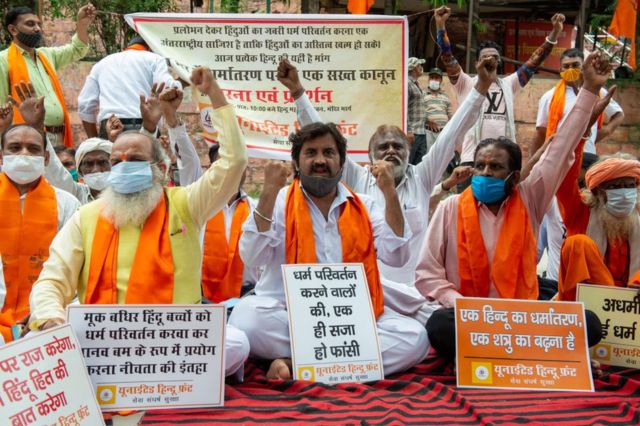 Jai Bhagwan Goyal President United Hindu Front and senior leader BJP along with other protesters chant slogans and hold placards during the demonstration in New Delhi.