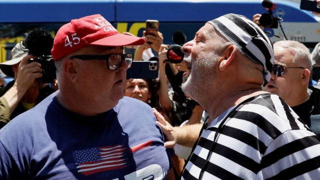 A supporter of former US President Donald Trump and an anti-Trump demonstrator argue near the Wilkie D. Ferguson Jr. United States Courthouse