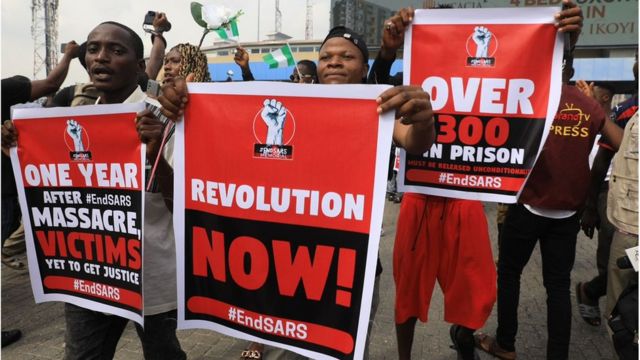 Youths hold Endsars placard for Lekki