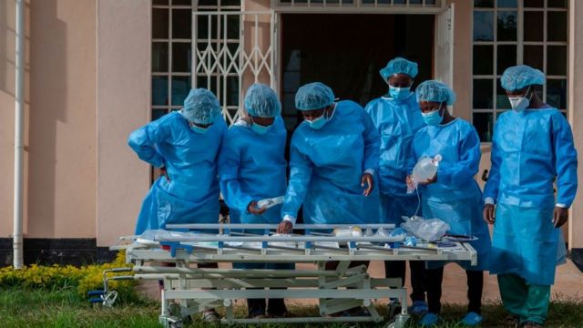 People in personal protective equipment are seen at a lodging building readying for their turn to go and work inside the main COVID-19 treatment centre at Kamuzu Central Hospital in Lilongwe, Malawi, on January 18, 2021.