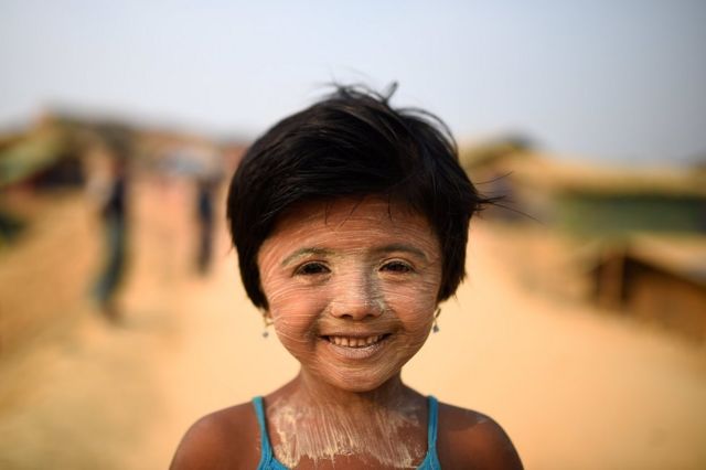 Rohingya refugee Nur Kayas, aged 6, poses for a photograph as she wears thanaka paste at Kutupalong camp in Cox's Bazaar, Bangladesh
