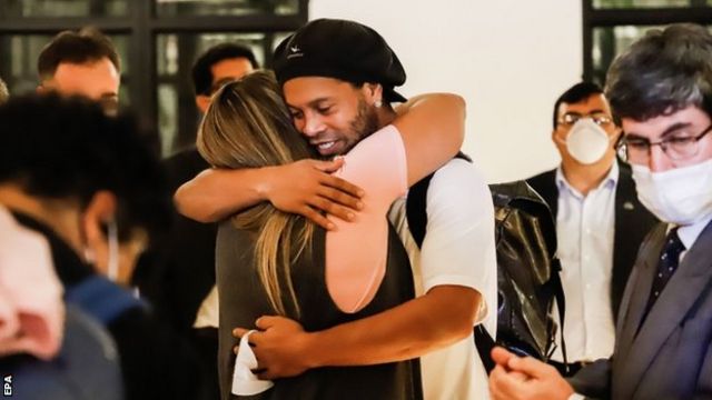 Ronaldinho was met by friends at the hotel he must now stay in in Asuncion