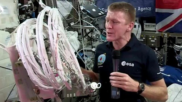 Tim Peake holds cable