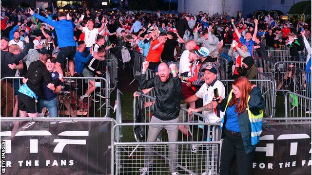 Fans in Manchester celebrate Harry Kane's winner against Denmark
