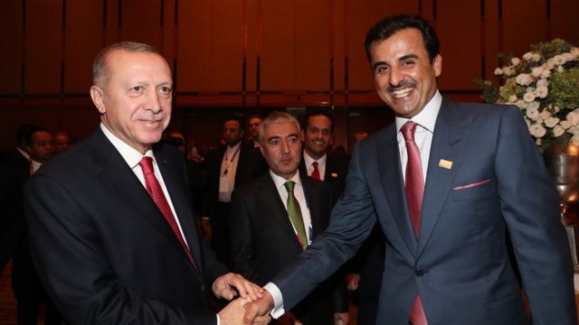 الرئيس التركي رجب طيب أردوغان يصافح الأمير القطري الشيخ تميم بن حمد آل ثاني