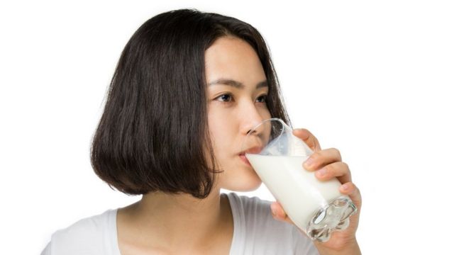 Mujer bebiendo un vaso de leche