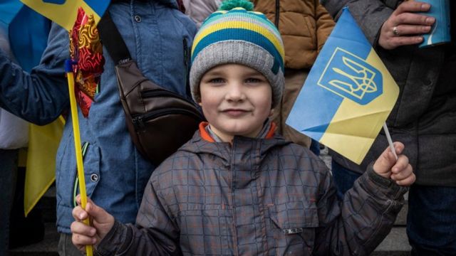 Seorang anak laki-laki tersenyum untuk kamera di Kyiv.