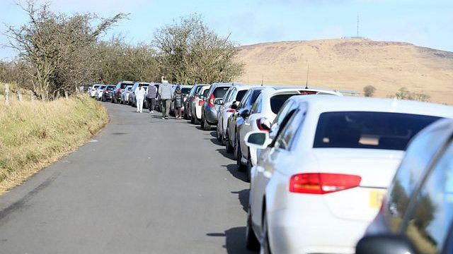 A line of cars parked a Divis Mountain in Belfast