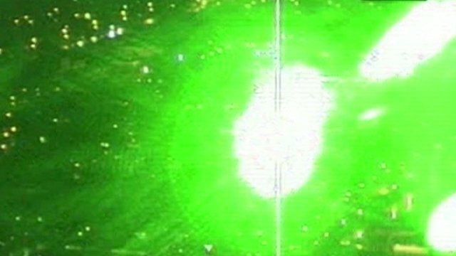 Green laser being beamed at planes