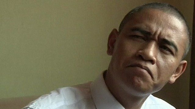 Barack Obama impersonator Xiao Jiguo demonstrates one of his 'Obama' looks