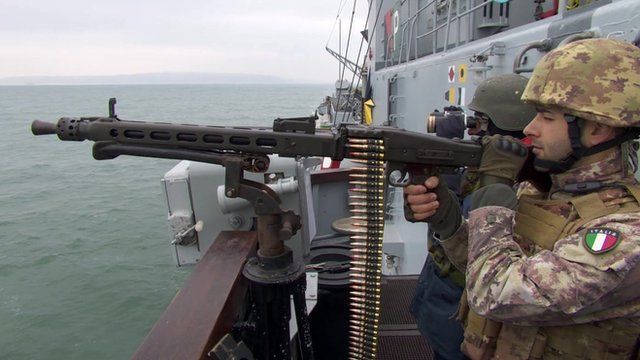 Soldier with rifle aboard Italian anti-submarine warship