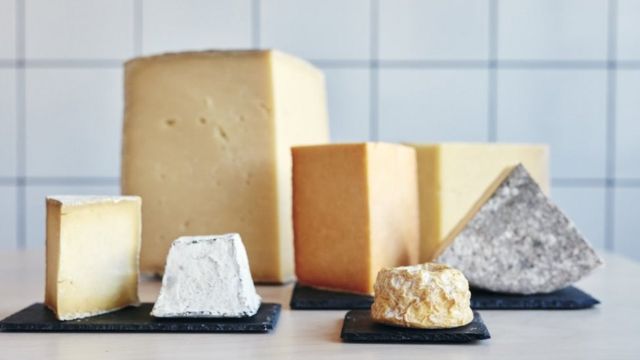Several different kinds of cheese on a table