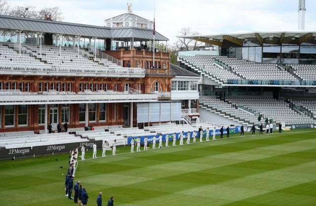 Players and staff at Lord's Cricket Ground hold a two-minute silence