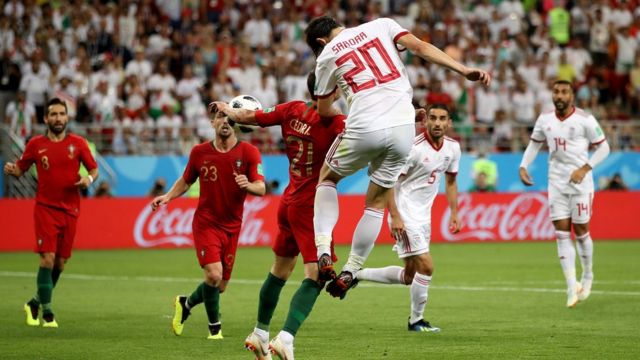 Sardar Azmoun of Iran heads the ball on Cedric of Portugal's arm to gain a penalty during the 2018 FIFA World Cup Russia group B match between Iran and Portugal at Mordovia Arena on June 25, 2018 in Saransk, Russia.