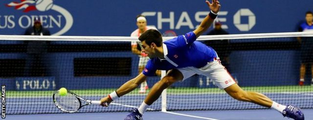 Novak Djokovic stretches for a backhand volley